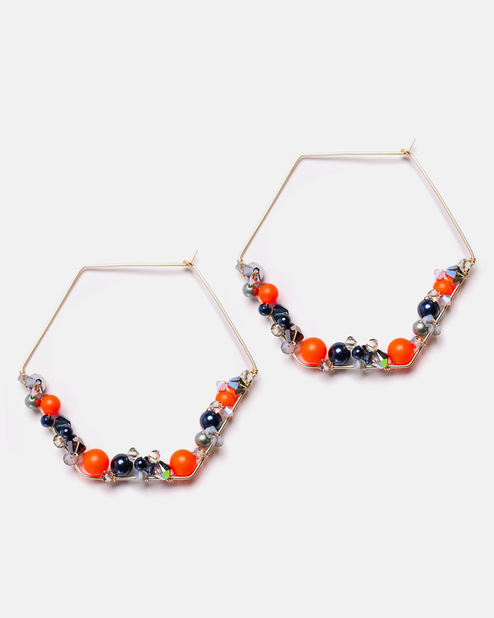 Endlessly wearable, these hexagon pieces are an original interpretation of a modern hoop earrings. Handcrafted in 14K gold-filled featuring neon orange pearls and colorful crystals.