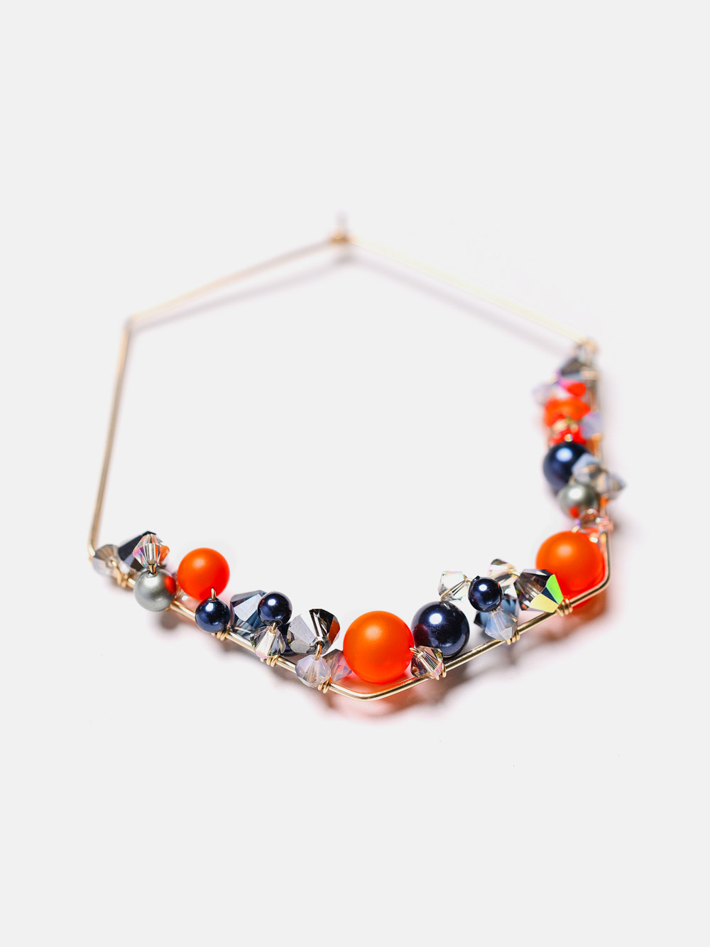 Endlessly wearable, these hexagon pieces are an original interpretation of a modern hoop earrings. Handcrafted in 14K gold-filled featuring neon orange pearls and colorful crystals.